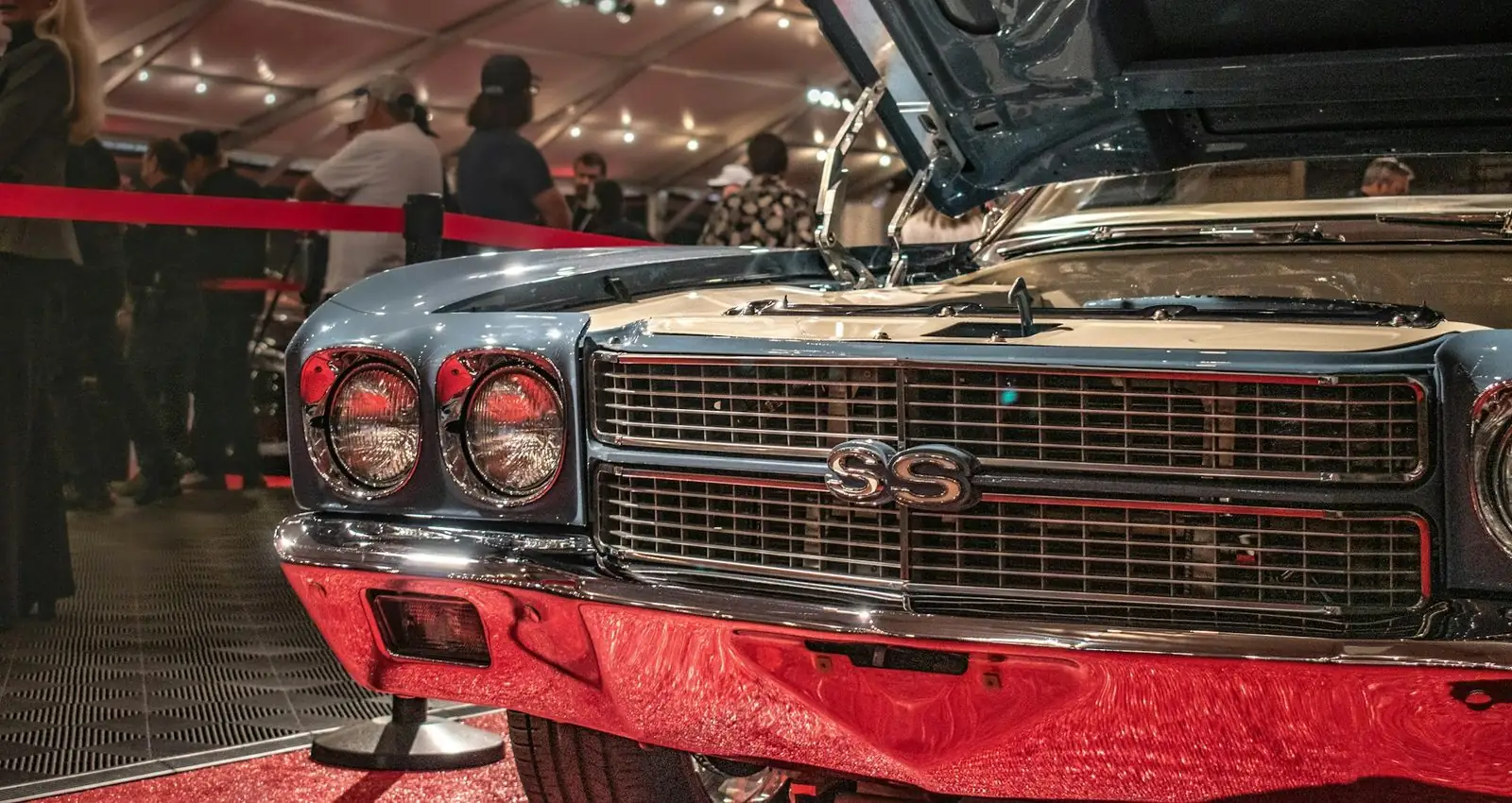 Front of a classic Chevrolet Chevelle SS with its hood open on display at a Barrett-Jackson collector car auction